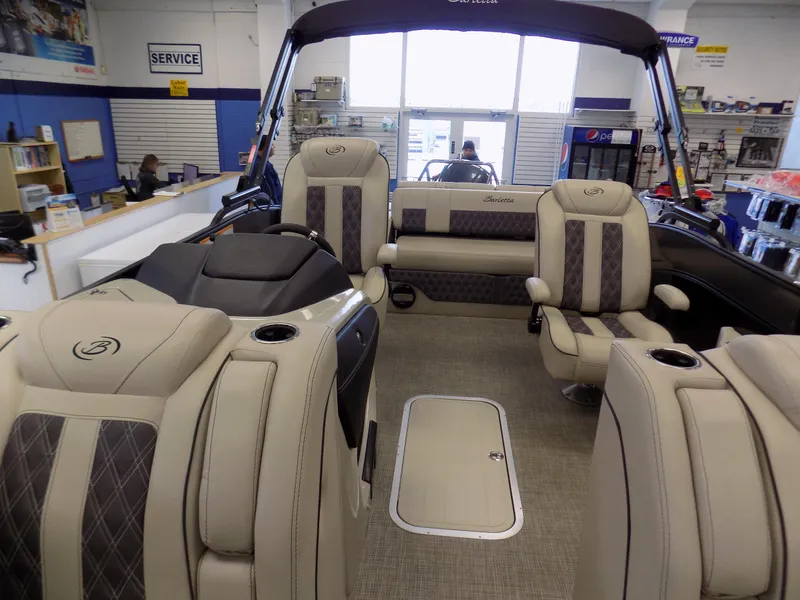 Slide: The Image of 2023 Barletta L23UC boat interior with luxurious seating and modern design in a showroom. - 8