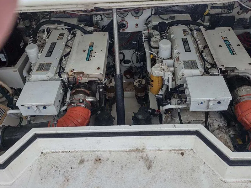 Slide: The Image of Engine compartment of a 1998 Cabo 31 Express boat, featuring dual engines and mechanical components. - 10