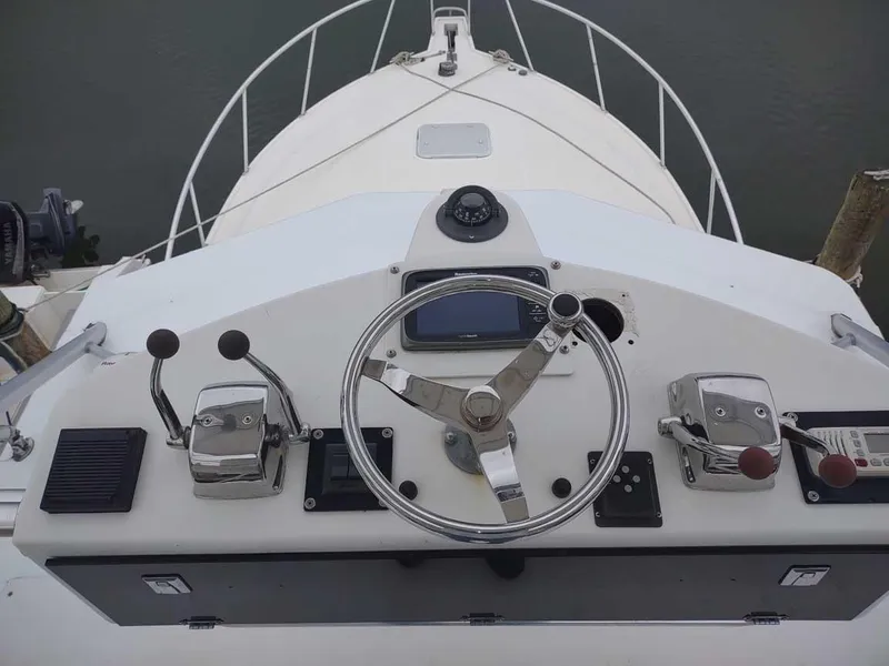 Slide: The Image of Helm of 1998 Cabo 31 Express boat with steering wheel and controls. - 11