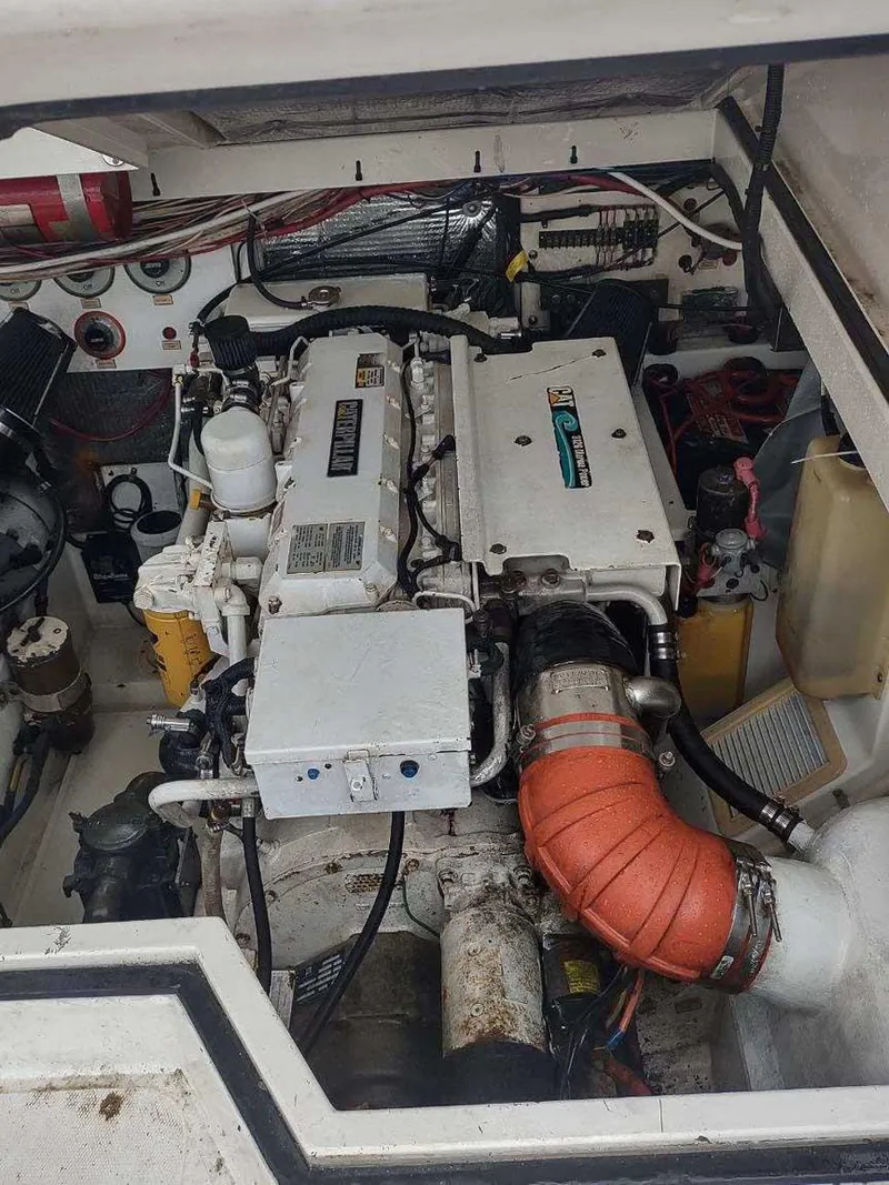 Slide: The Image of Engine compartment of a 1998 Cabo 31 Express boat, showcasing mechanical components and wiring. - 13