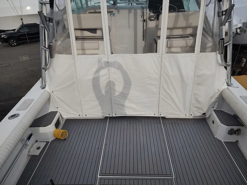 Slide: The Image of 1998 Cabo 31 Express boat deck with seating and protective cover. - 3