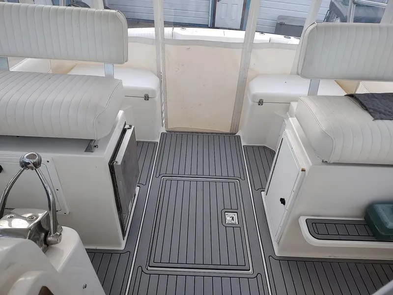 Slide: The Image of 1998 Cabo 31 Express boat interior with white seating and gray flooring. - 6