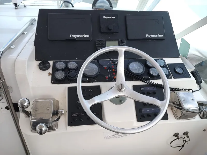 Slide: The Image of Helm of 1998 Cabo 31 Express boat with Raymarine navigation equipment and steering wheel. - 7