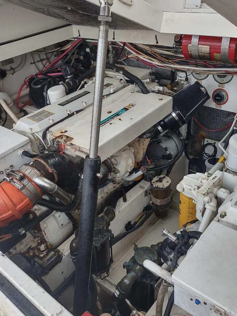 Slide: The Image of Engine compartment of a 1998 Cabo 31 Express boat, showcasing mechanical components and wiring. - 9