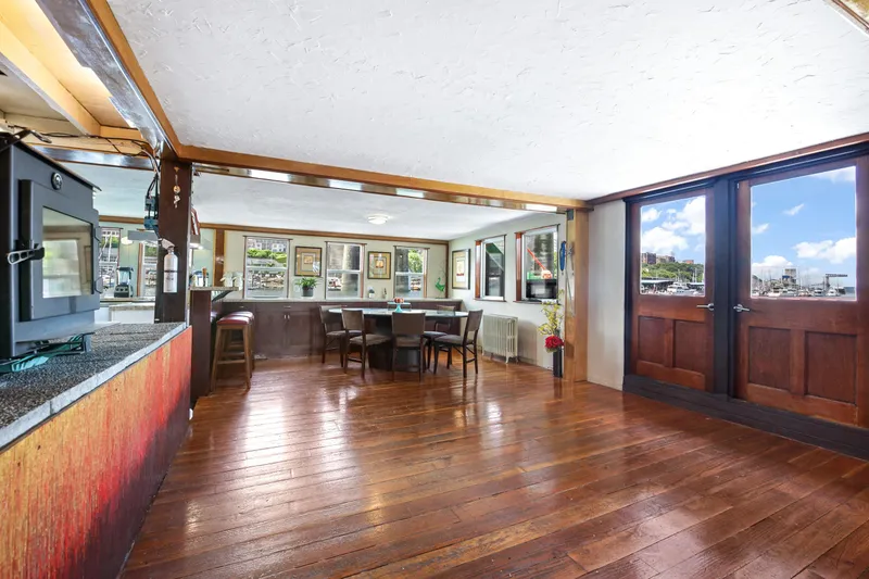 Slide: The Image of Spacious interior of a 1938 custom ferry with wooden floors and large windows. - 30
