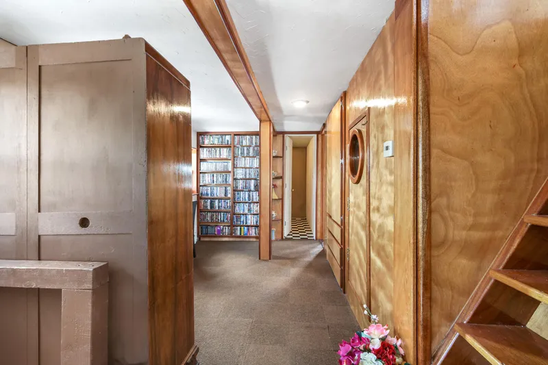 Slide: The Image of 1938 Custom Ferry interior with wooden paneling and built-in shelving. - 31