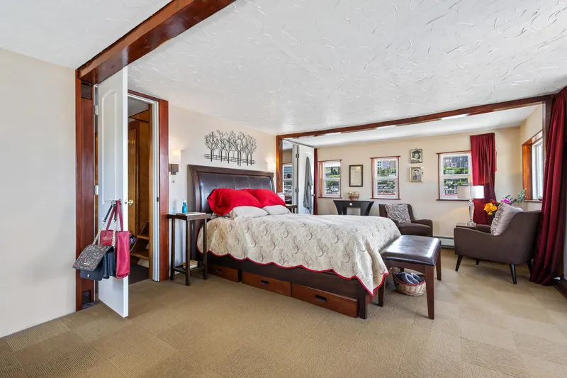 Slide: The Image of Spacious bedroom on a 1938 Ferry Custom with modern decor and cozy seating area. - 32