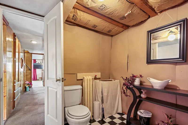Slide: The Image of Basement bathroom with checkered floor, exposed ceiling, and decorative vanity. - 36