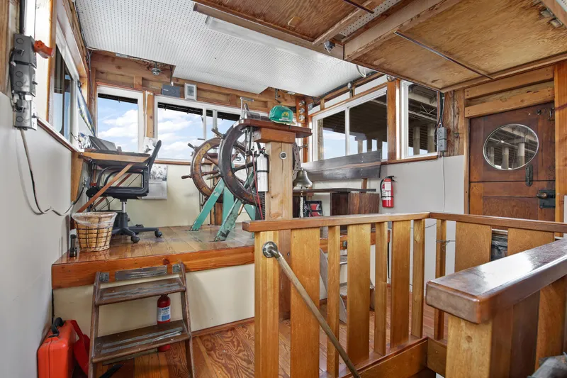 Slide: The Image of 1938 custom ferry interior with wooden helm, vintage controls, and nautical decor. - 38