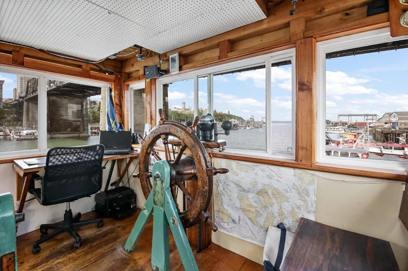 Slide: The Image of 1938 Custom Ferry interior with vintage steering wheel and modern office setup. - 4