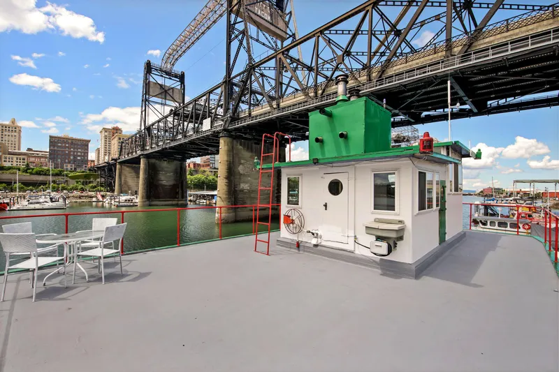 Slide: The Image of 1938 Custom Ferry with deck view, bridge, and cityscape in the background. - 40