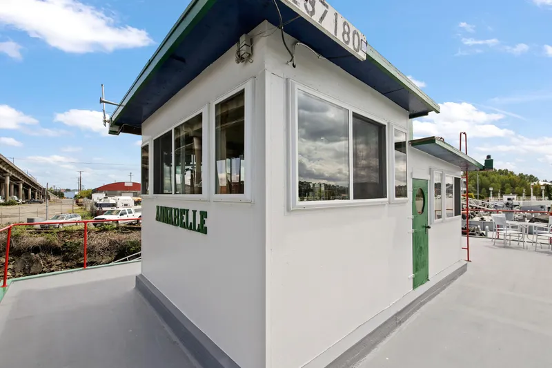 Slide: The Image of 1938 Custom Ferry with white cabin and green accents docked at a marina. - 41