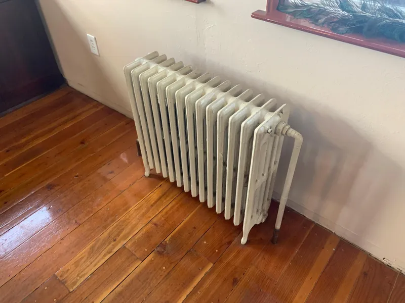 Slide: The Image of Vintage 1938 Ferry Custom radiator on polished wooden floor. - 43