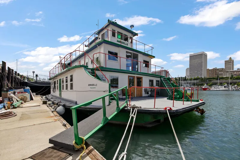 Slide: The Image of 1938 Custom Ferry docked at a marina with city skyline in the background. - 7