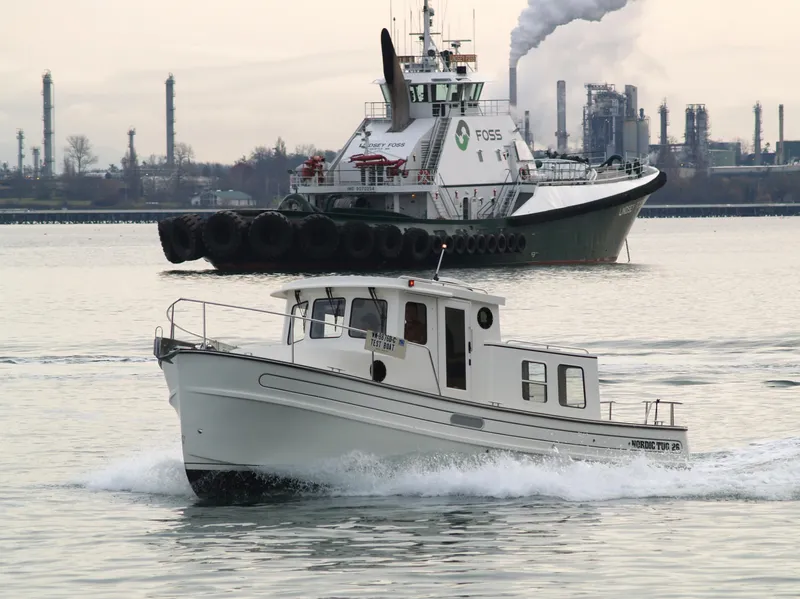 Slide: The Image of Nordic Tug 26 (2025) cruising in industrial harbor with tugboat in background. - 3