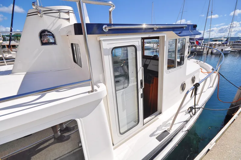 Slide: The Image of 2025 Nordic Tug 34 docked at a marina on a sunny day. - 10