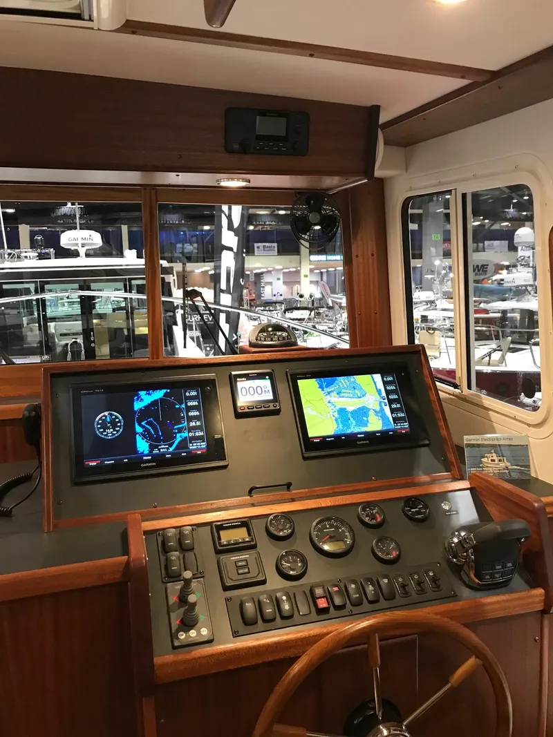Slide: The Image of 2025 Nordic Tug 34 helm with advanced navigation systems and controls. - 4