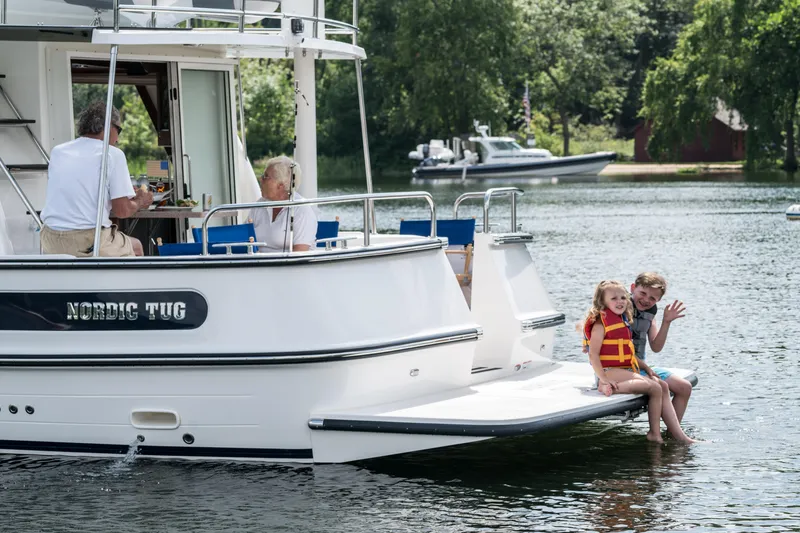 Slide: The Image of Family enjoying a day on a 2025 Nordic Tug 40 boat. - 14