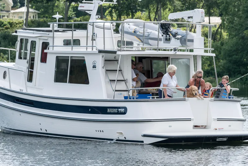 Slide: The Image of 2025 Nordic Tug 40 boat with family enjoying a day on the water. - 17