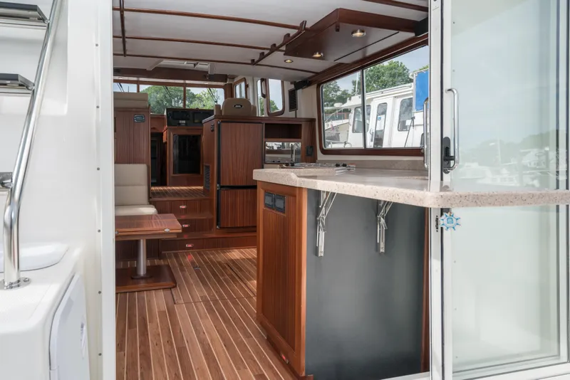 Slide: The Image of Interior of 2025 Nordic Tug 40 with modern wood finish and spacious layout. - 9