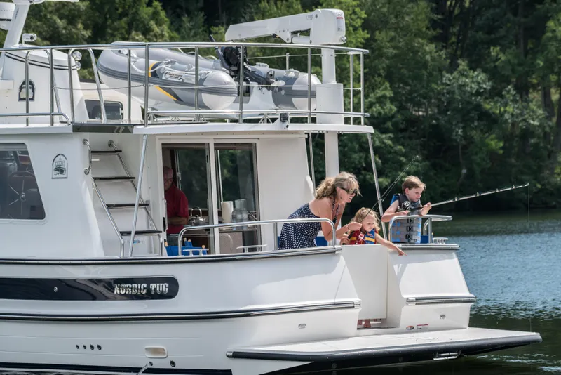 Slide: The Image of Family enjoying fishing on a 2025 Nordic Tug 40 boat. - 15