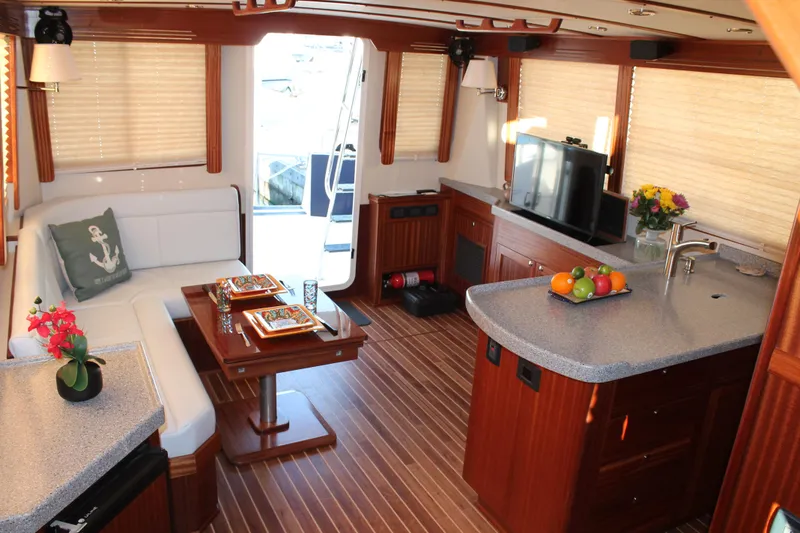 Slide: The Image of Luxurious 2025 Nordic Tug 44 interior with modern kitchen, dining area, and cozy seating. - 2