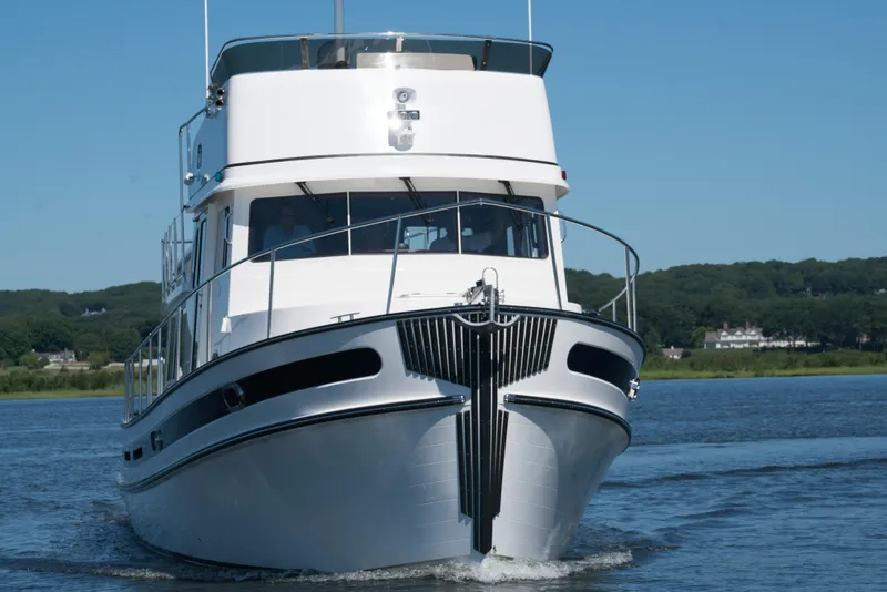 Slide: The Image of 2025 Nordic Tug 44 cruising on a serene lake. - 7