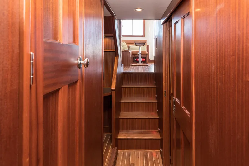 Slide: The Image of Interior hallway of 2025 Nordic Tug 44 with wooden stairs and doors. - 5