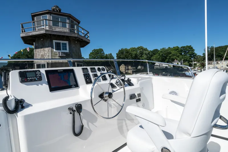 Slide: The Image of Nordic Tug 44 (2025) helm station with modern navigation equipment and comfortable seating. - 8