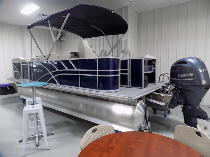 Slide: The Image of 2022 Sylvan Mirage Fish 8522 Party Fish pontoon boat in showroom with Yamaha motor. - 1