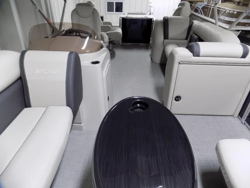 Slide: The Image of 2022 Sylvan Mirage Fish 8522 Party Fish interior with plush seating and sleek table. - 4