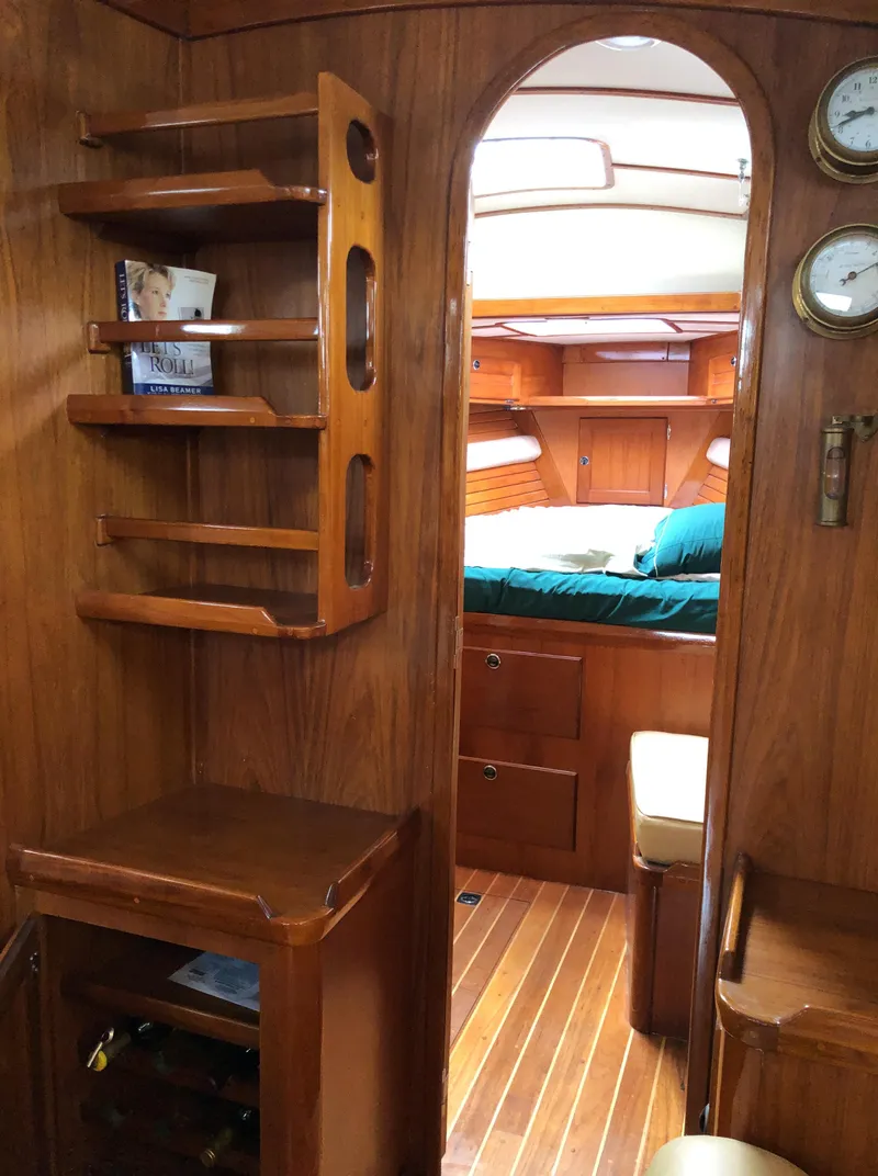 Slide: The Image of Interior of a 1995 Valiant 50 yacht with wooden shelves and cozy cabin. - 15
