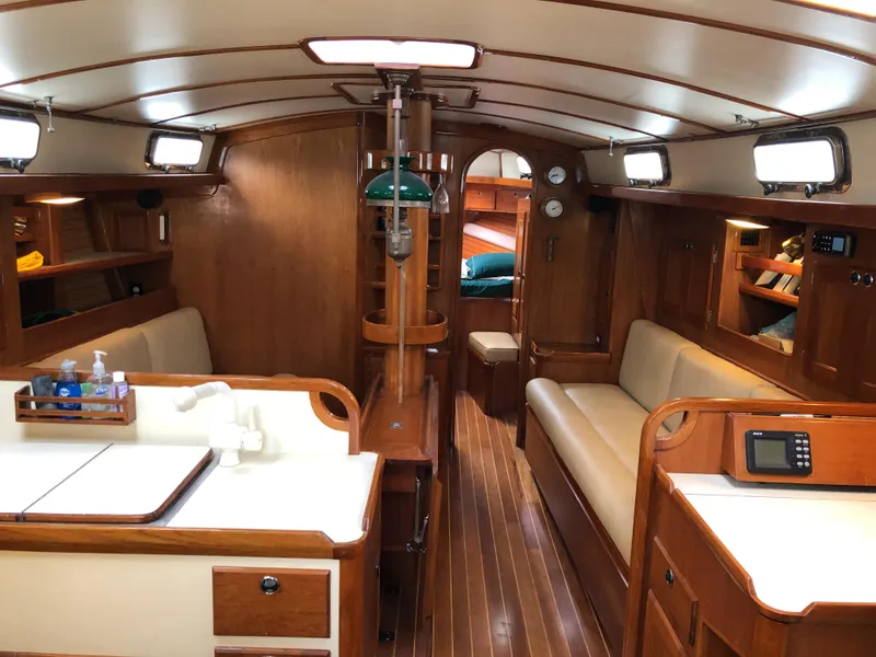 Slide: The Image of Interior of a 1995 Valiant 50 yacht with wooden furnishings and cozy seating. - 17