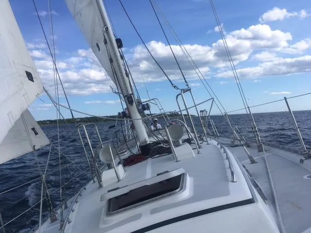 Slide: The Image of Sailing on a 1995 Valiant 50 yacht under clear skies and calm sea. - 2