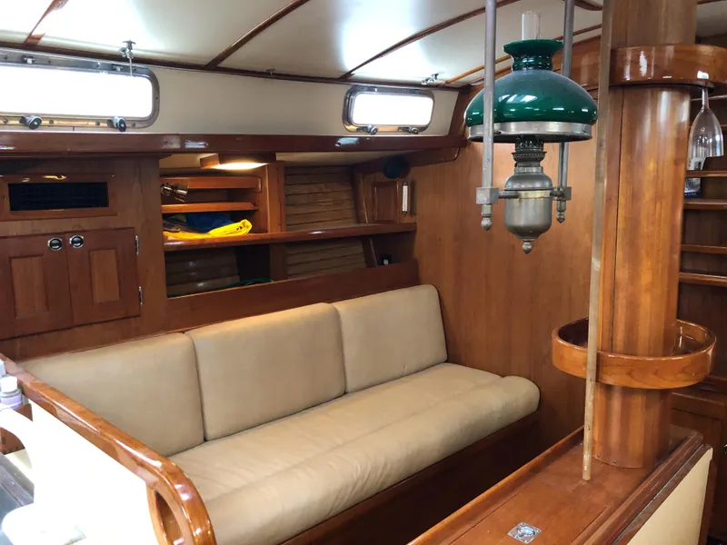 Slide: The Image of Interior of 1995 Valiant 50 yacht with wooden furnishings and beige seating. - 20