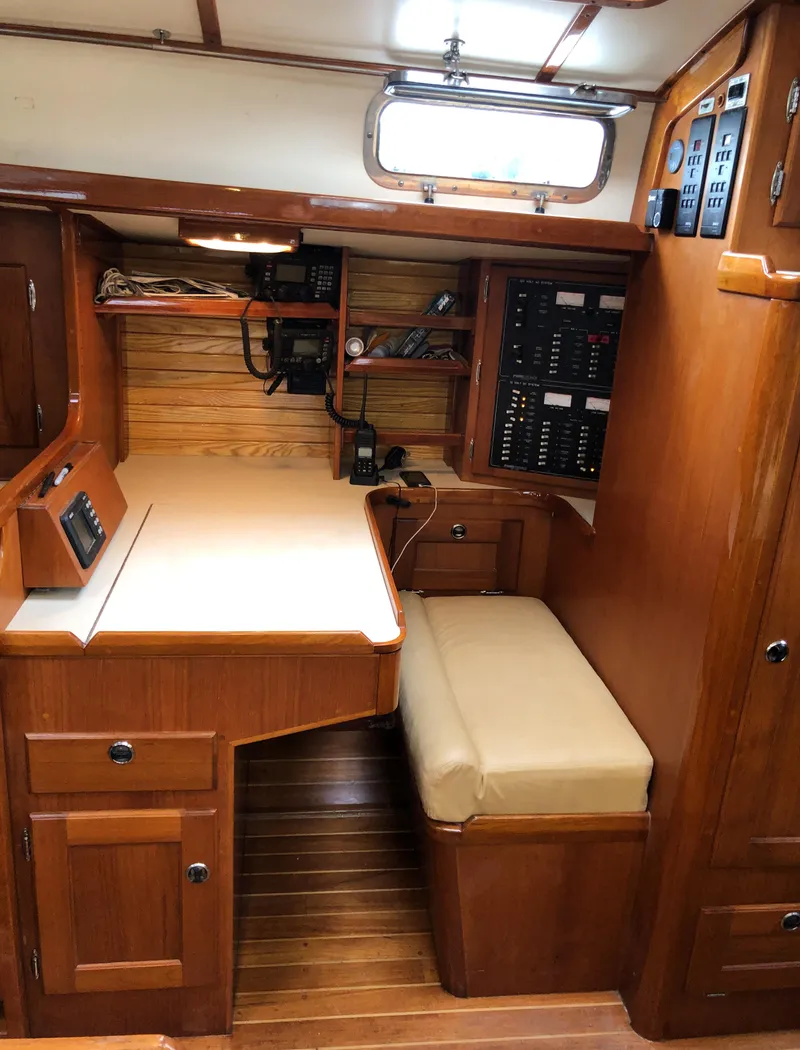Slide: The Image of 1995 Valiant 50 yacht interior with wooden cabinetry and navigation station. - 22