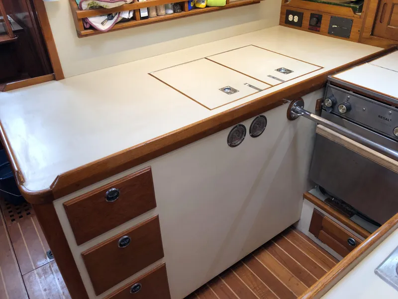 Slide: The Image of 1995 Valiant 50 yacht kitchen with wooden cabinets and modern appliances. - 29