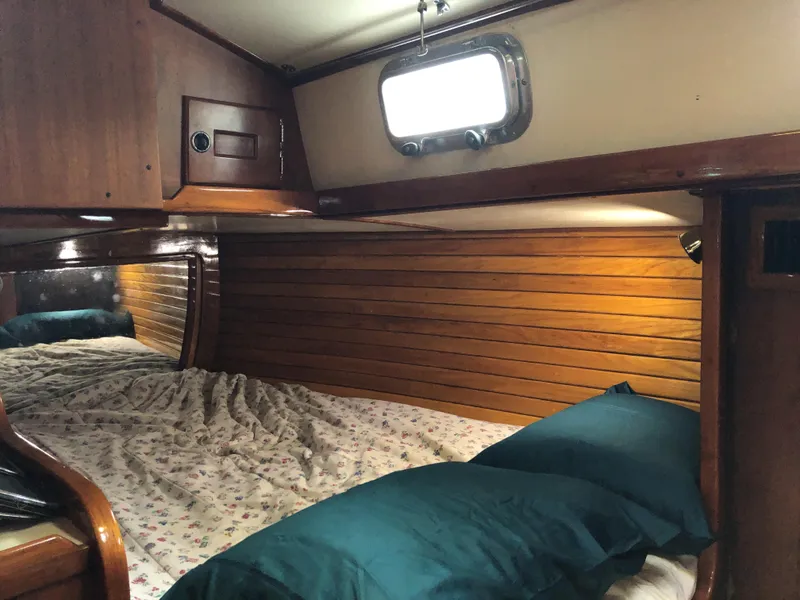Slide: The Image of Cozy cabin interior of 1995 Valiant 50 yacht with wooden paneling and bedding. - 30