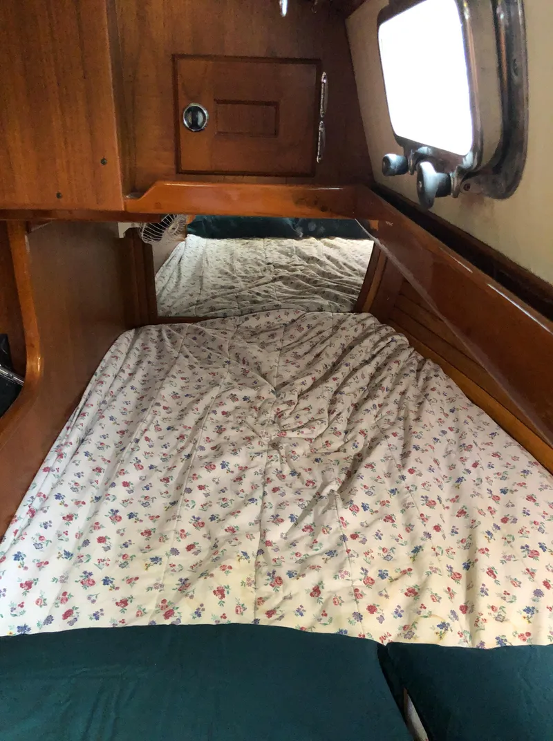 Slide: The Image of Cozy cabin interior of 1995 Valiant 50 sailboat with floral bedding. - 32