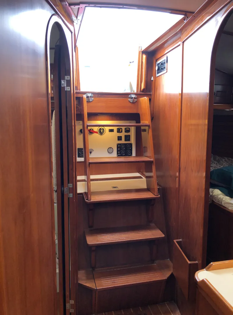 Slide: The Image of Wooden interior stairs on a 1995 Valiant 50 yacht, leading to the deck. - 37