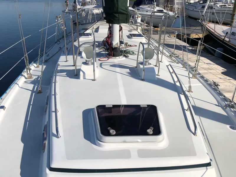 Slide: The Image of Deck of a 1995 Valiant 50 sailboat, docked at a marina. - 7