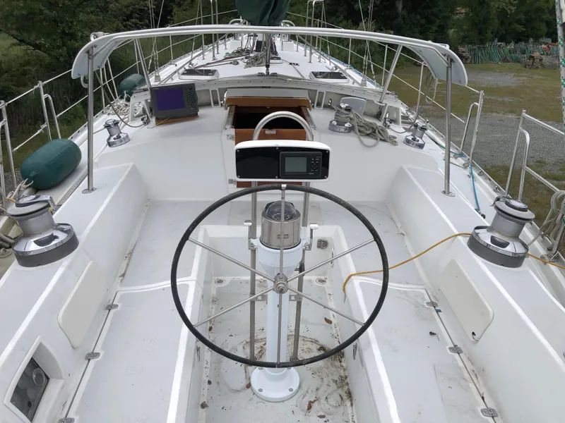Slide: The Image of 1995 Valiant 50 sailboat cockpit with steering wheel and navigation equipment. - 8