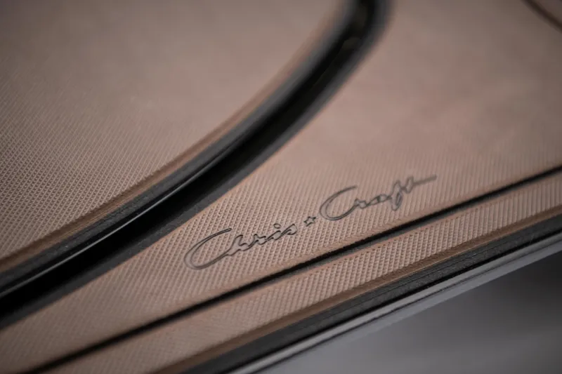 Slide: The Image of 2024 Chris-Craft Calypso 35 boat docked near a white fence with American flag. - 3