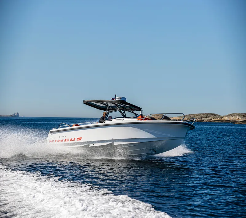 Slide: The Image of 2025 Nimbus T8 boat cruising on open water under clear blue sky. - 0