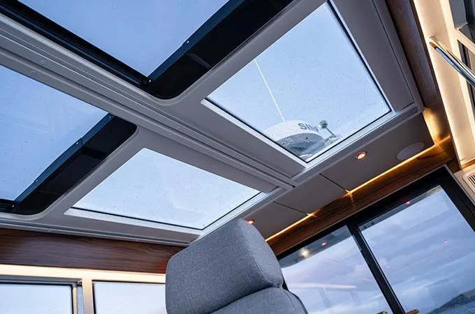 Slide: The Image of Interior view of 2025 Nimbus C11 boat with panoramic sunroof. - 3