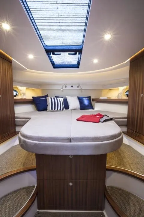 Slide: The Image of Luxurious interior of 2025 Nimbus 405 Coupé yacht with skylight and cozy bedding. - 12