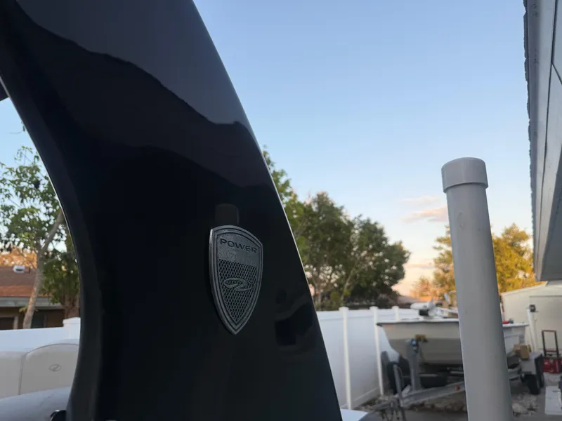 Slide: The Image of 2013 Regal 2500 Bowrider boat detail with Power Tower emblem, outdoor setting. - 10