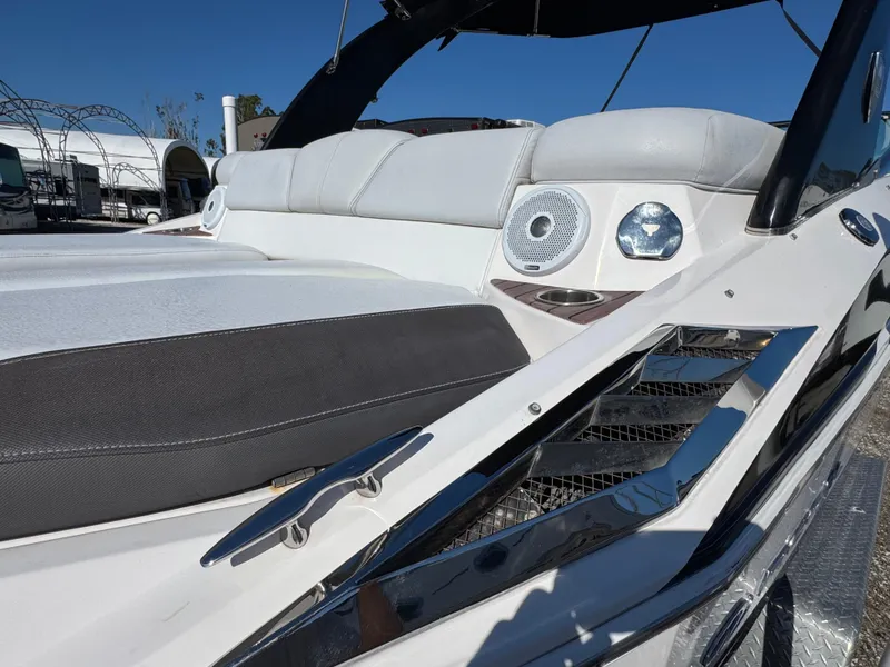 Slide: The Image of 2013 Regal 2500 Bowrider boat interior with cushioned seating and speaker system. - 12