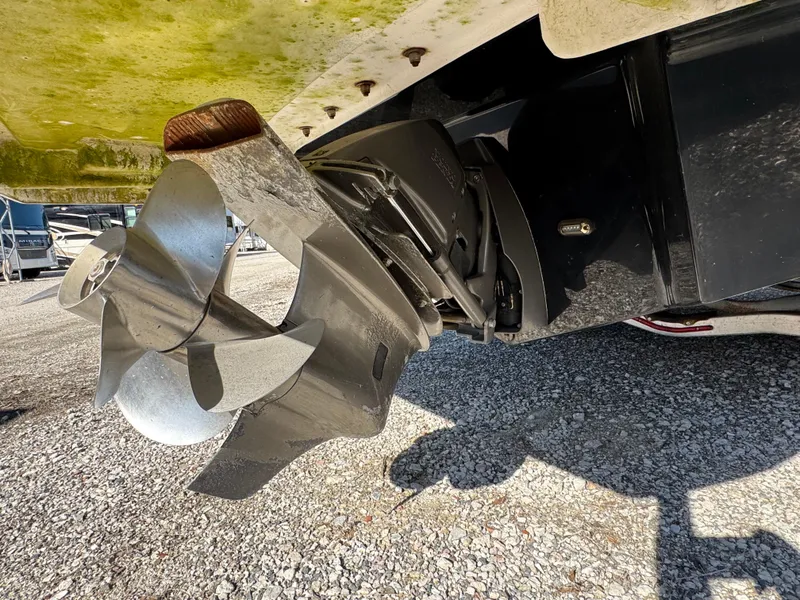 Slide: The Image of Close-up of 2013 Regal 2500 Bowrider boat propeller on gravel surface. - 13