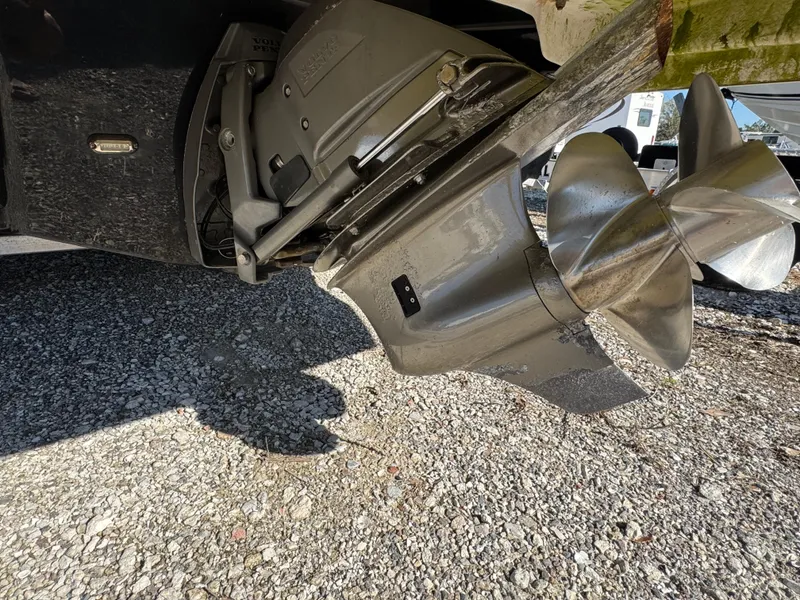 Slide: The Image of 2013 Regal 2500 Bowrider propeller and drive system on gravel surface. - 14